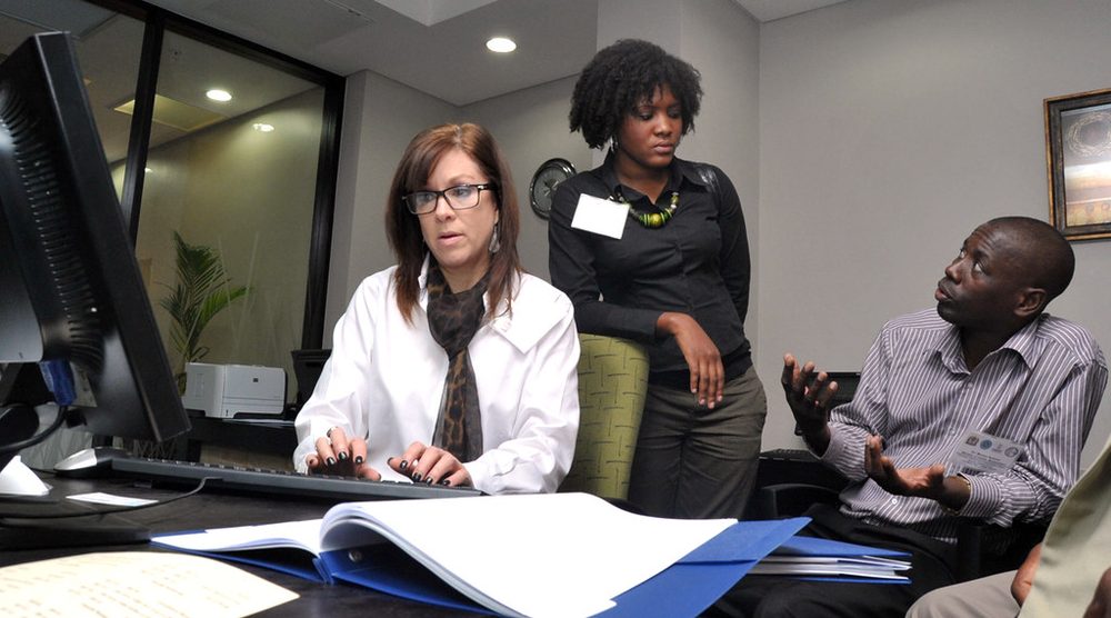 Colleagues reviewing work together at a desk